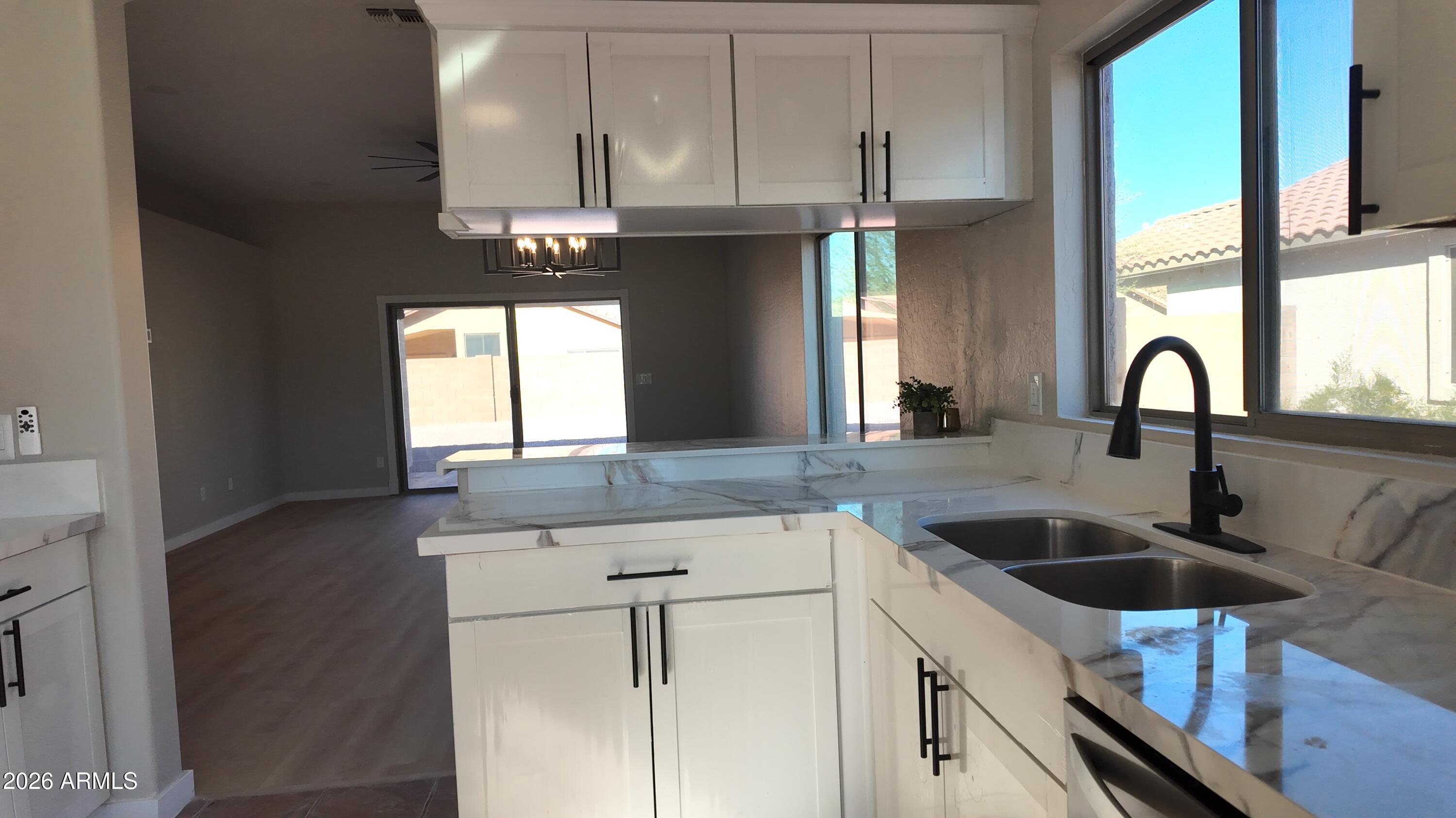 1522 East Chambers Street Phoenix, AZ 85040 - Photo 9 of 29 a kitchen with stainless steel appliances granite countertop a sink a stove and a refrigerator