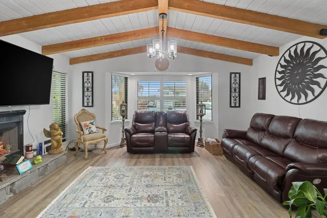 a living room with furniture ceiling fan and a rug