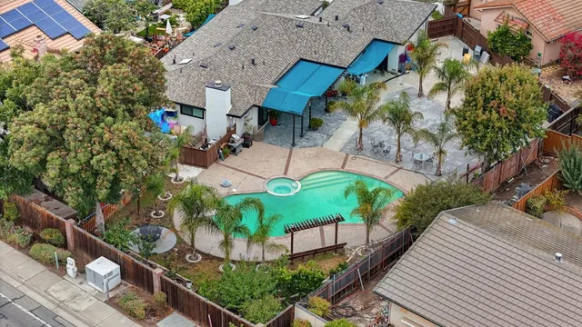 an aerial view of a house with a yard and potted plants
