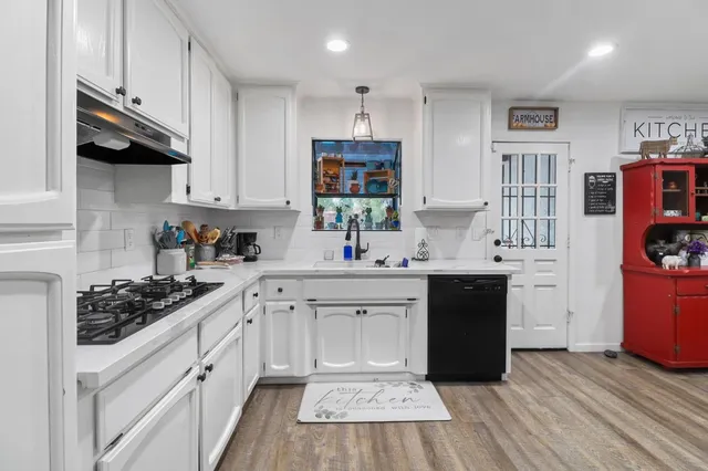 a kitchen with stainless steel appliances a sink stove and cabinets