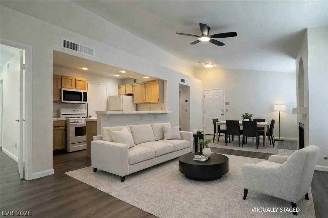 7570 West Flamingo Road, Unit 209 Las Vegas, NV 89147 - Photo 8 of 30 Living room featuring a ceiling fan, dark wood-style flooring, recessed lighting, and vaulted ceiling
