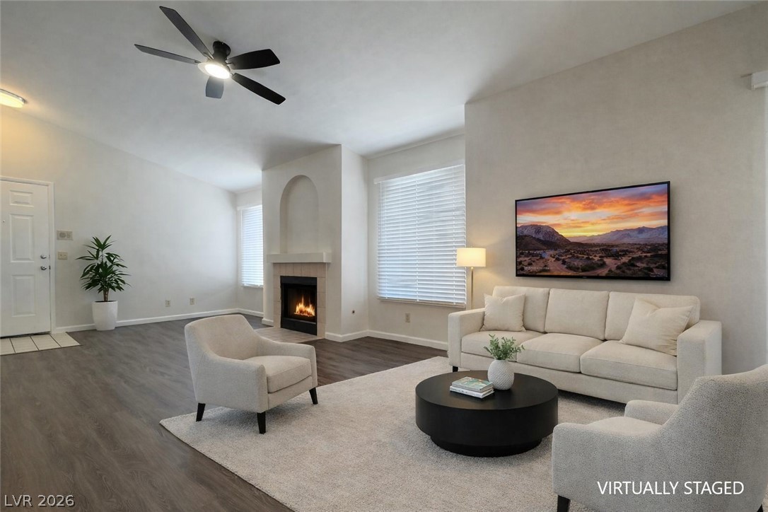 7570 West Flamingo Road, Unit 209 Las Vegas, NV 89147 - Photo 9 of 30 Living room with dark wood-style flooring, ceiling fan, a tiled fireplace, and lofted ceiling