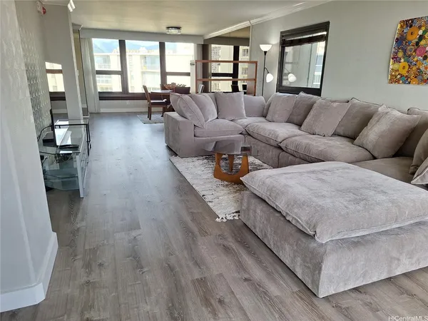 a living room with furniture and painting on the wall