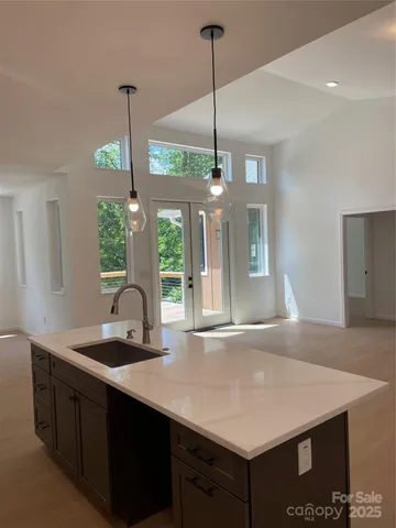 a kitchen with a sink a counter space and a fireplace