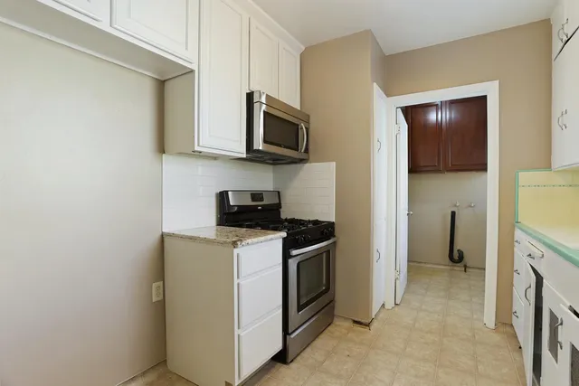 a kitchen with stainless steel appliances granite countertop a stove and a refrigerator