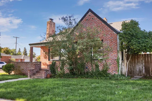 a front view of a house with a garden