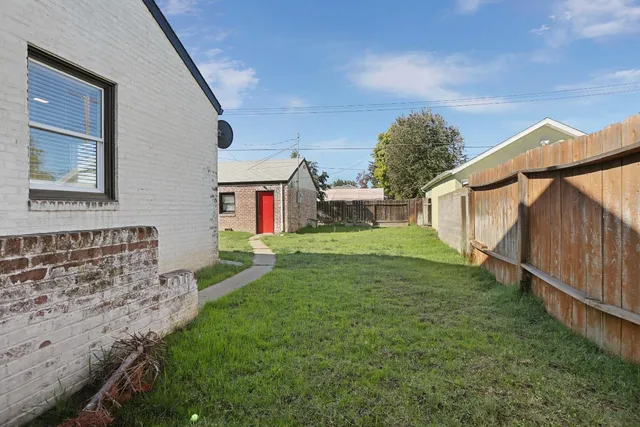 a view of house with backyard