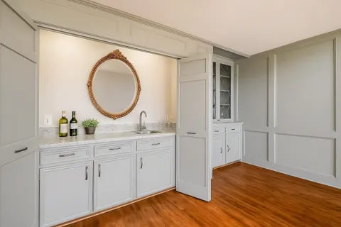 a spacious bathroom with a granite countertop double vanity sink and a mirror