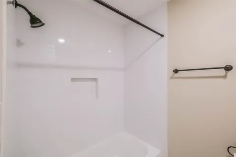 a bedroom with a bed and a chair