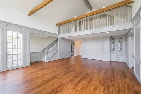 a view of an entryway with wooden floor