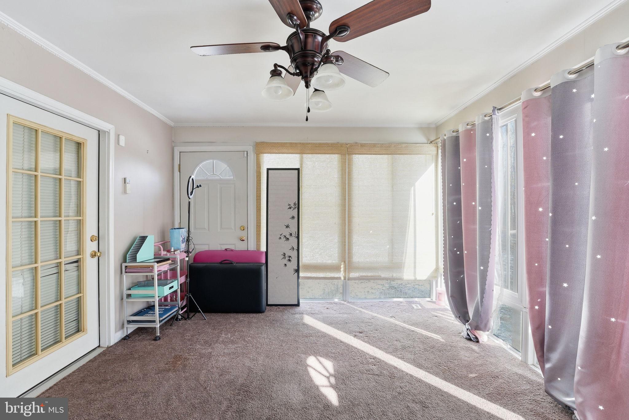 6870 Hawkins Gate Road La Plata, MD 20646 - Photo 13 of 24 a living room with a large bed and a chandelier