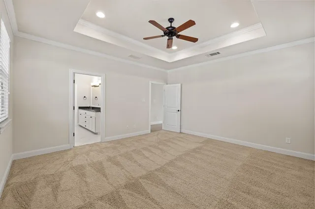 a view of an empty room with a ceiling fan