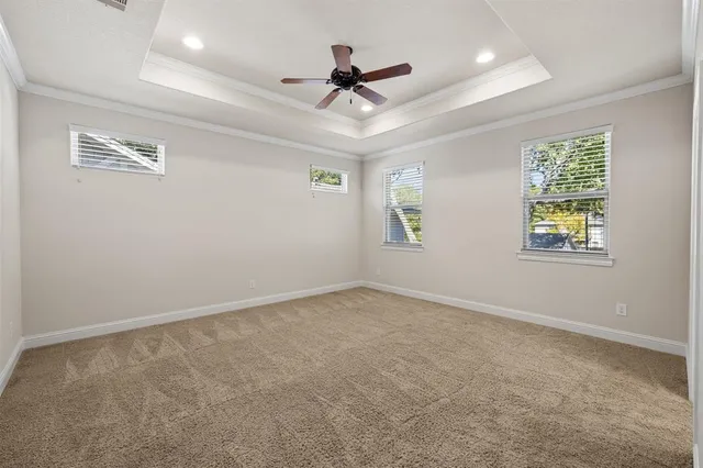 an empty room with window and ceiling fan