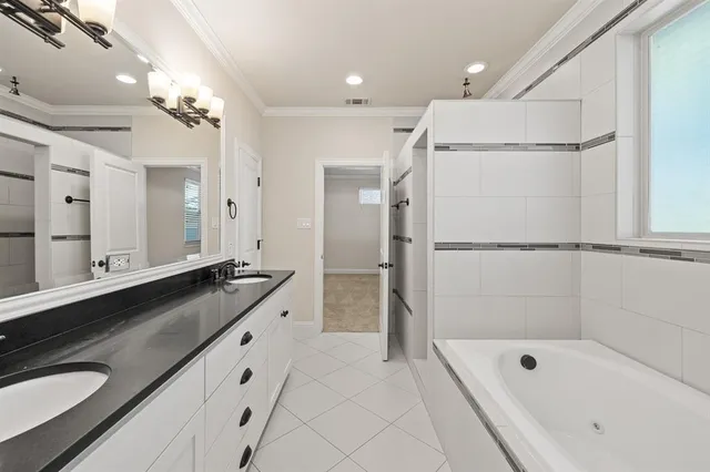 a bathroom with a granite countertop sink mirror and a bathtub