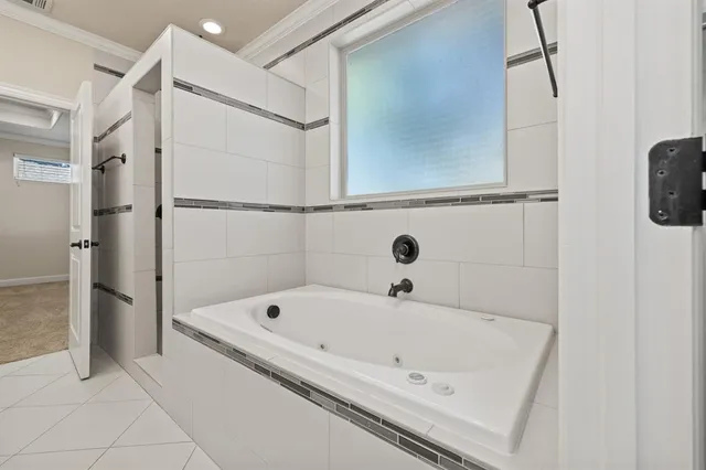 a bathroom with a tub and a shower