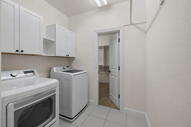 a view of storage and utility room with washer and dryer
