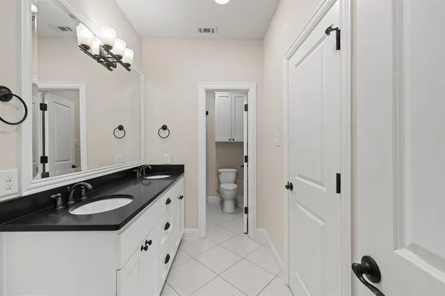 a bathroom with a granite countertop sink a mirror and a shower