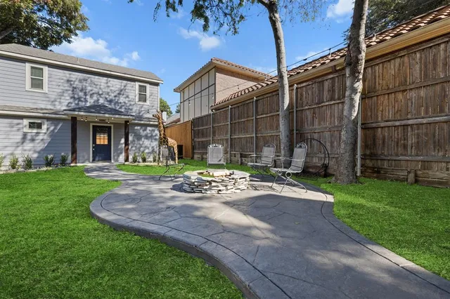 a view of a house with a small yard and plants