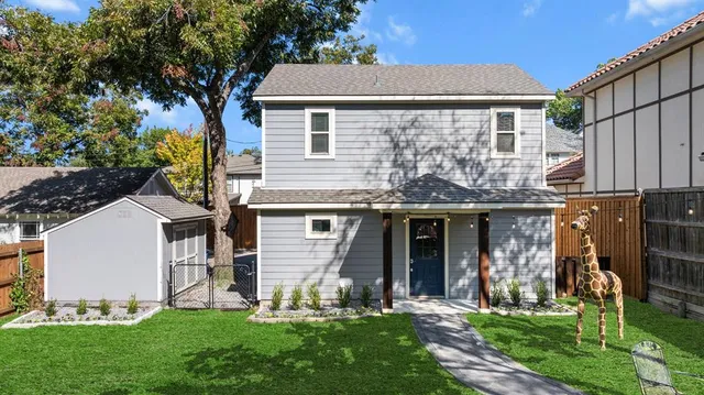 a front view of a house with a garden and plants