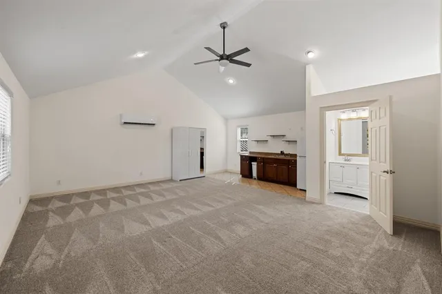 a living room with furniture and kitchen view