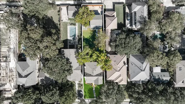 an aerial view of a house with a yard and garden