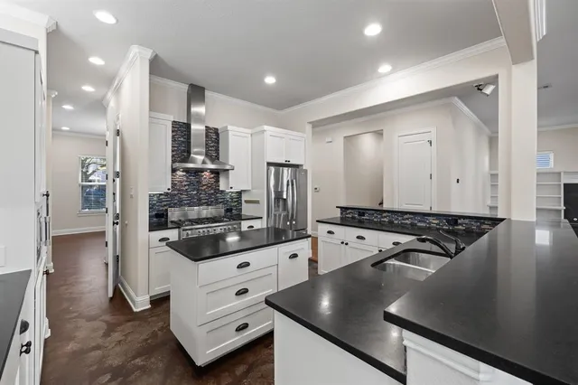 a kitchen with stainless steel appliances granite countertop a stove and a refrigerator
