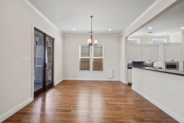 a view of a kitchen with wooden floor and a window
