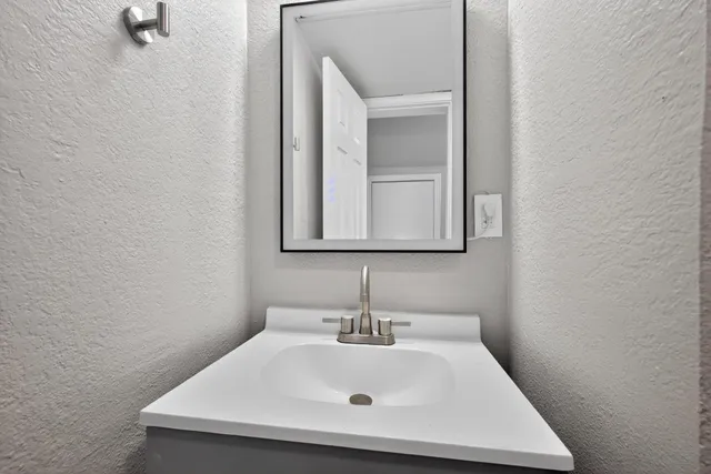 a bathroom with a sink and a mirror