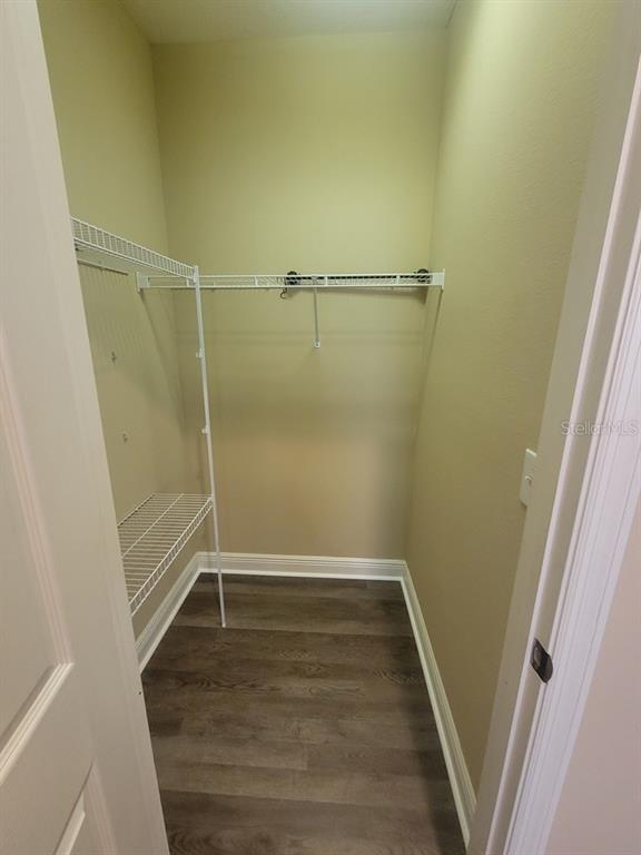 10418 Fenceline Road New Port Richey, FL 34655 - Photo 21 of 36 a view of a room with wooden floor and white doors
