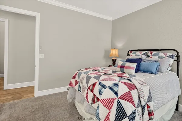 a bedroom with a bed and a lamp