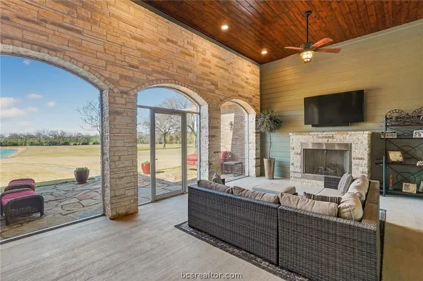 a living room with fireplace furniture and a flat screen tv