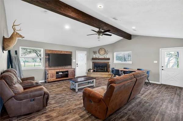 a living room with furniture and a wooden floor