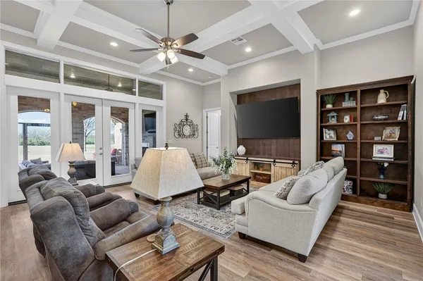 a living room with furniture a lamp and a flat screen tv