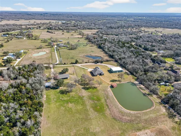 an aerial view of a house with a lake view