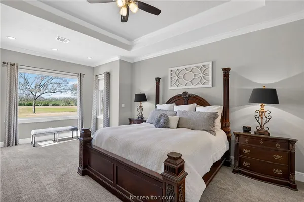 a bedroom with a bed and a painting on the wall