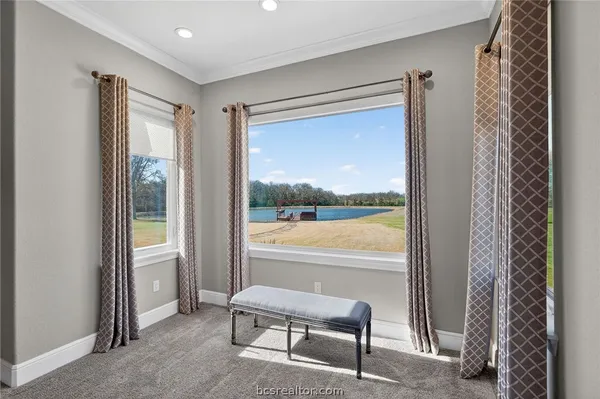 a view of a room with a large window and chair