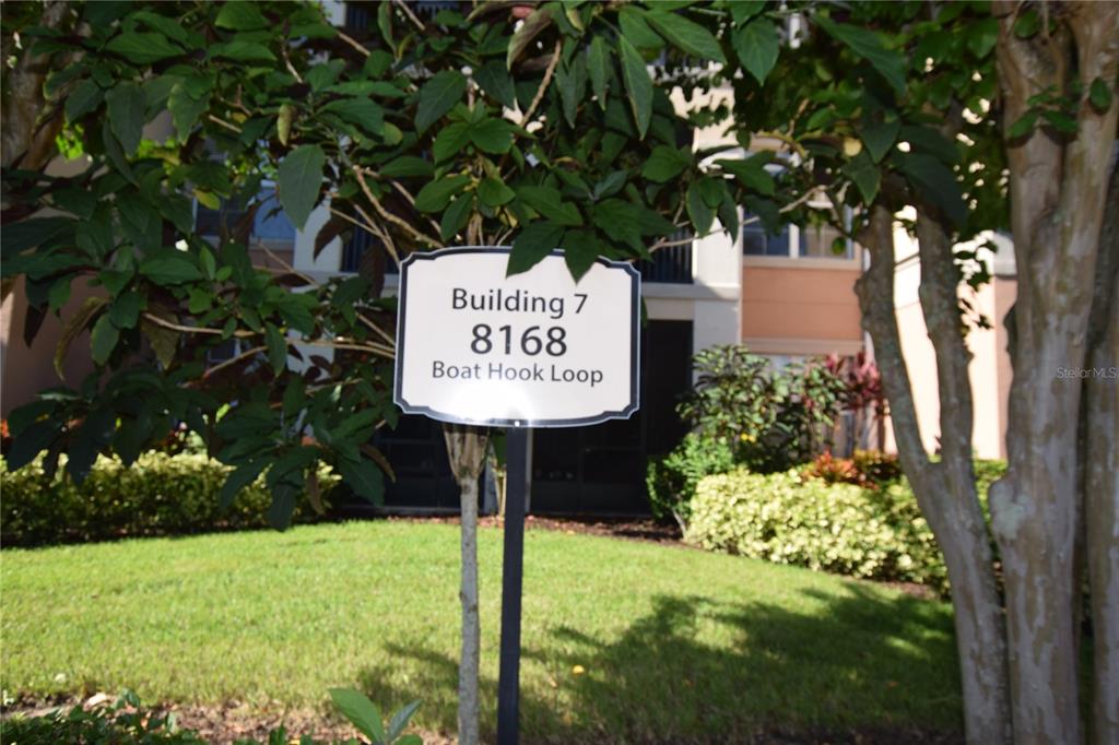 8168 Boat Hook Loop, Unit 725 Windermere, FL 34786 - Photo 2 of 35 a sign on the side of a tree