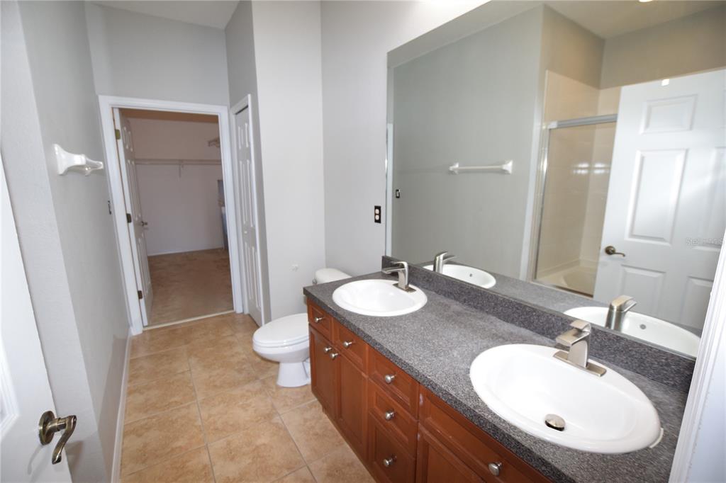 8168 Boat Hook Loop, Unit 725 Windermere, FL 34786 - Photo 22 of 35 a bathroom with a double vanity sink and a mirror