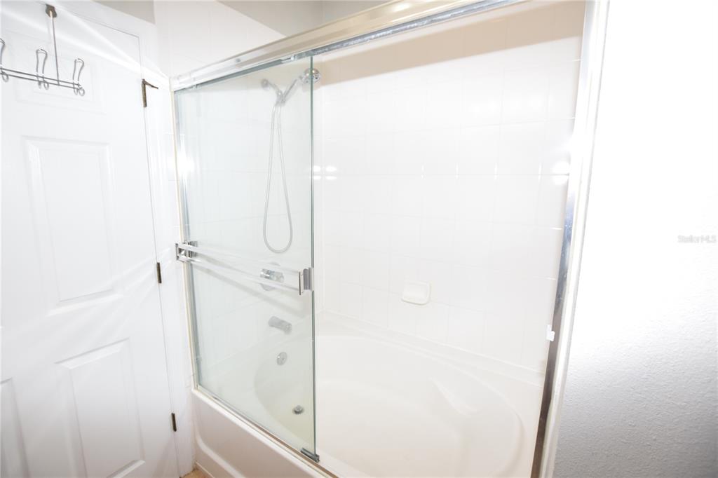 8168 Boat Hook Loop, Unit 725 Windermere, FL 34786 - Photo 23 of 35 a bathroom with a glass shower door
