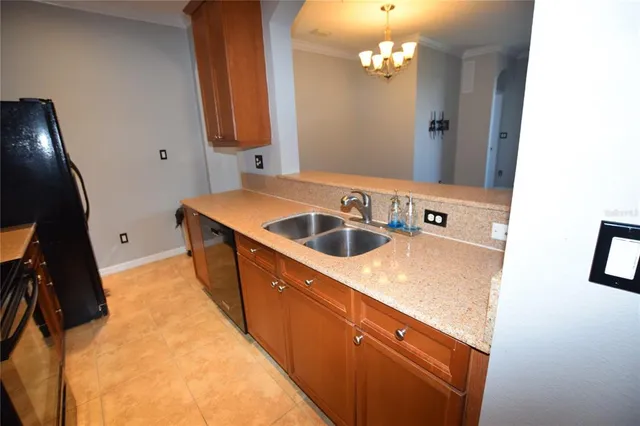 a kitchen with stainless steel appliances granite countertop a refrigerator a stove and a microwave