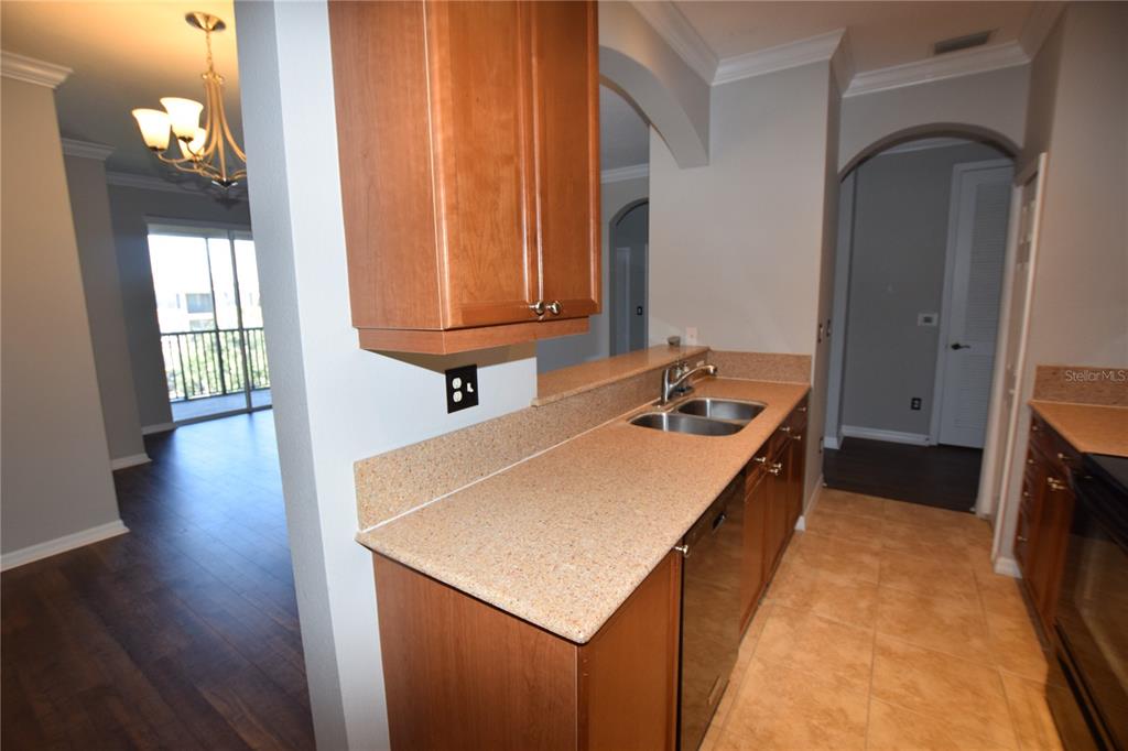 8168 Boat Hook Loop, Unit 725 Windermere, FL 34786 - Photo 29 of 35 a kitchen with a sink a stove and wooden floor