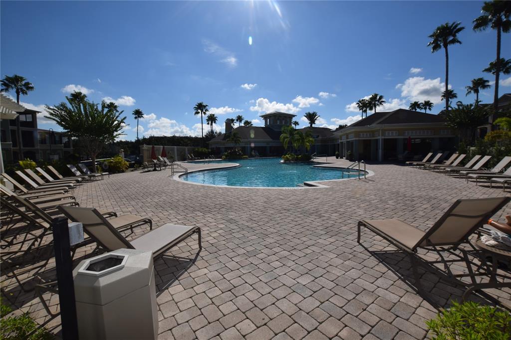 8168 Boat Hook Loop, Unit 725 Windermere, FL 34786 - Photo 32 of 35 a view of a patio with table and chairs a barbeque with wooden fence
