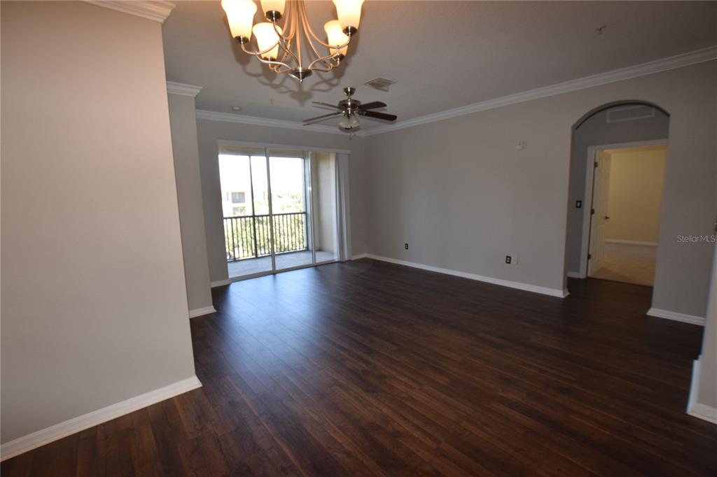 8168 Boat Hook Loop, Unit 725 Windermere, FL 34786 - Photo 4 of 35 a view of an empty room with wooden floor and a window