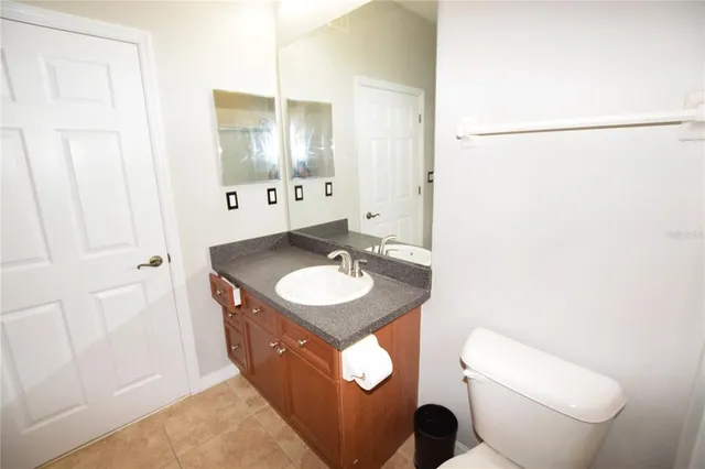 a bathroom with a sink and a mirror with toilet