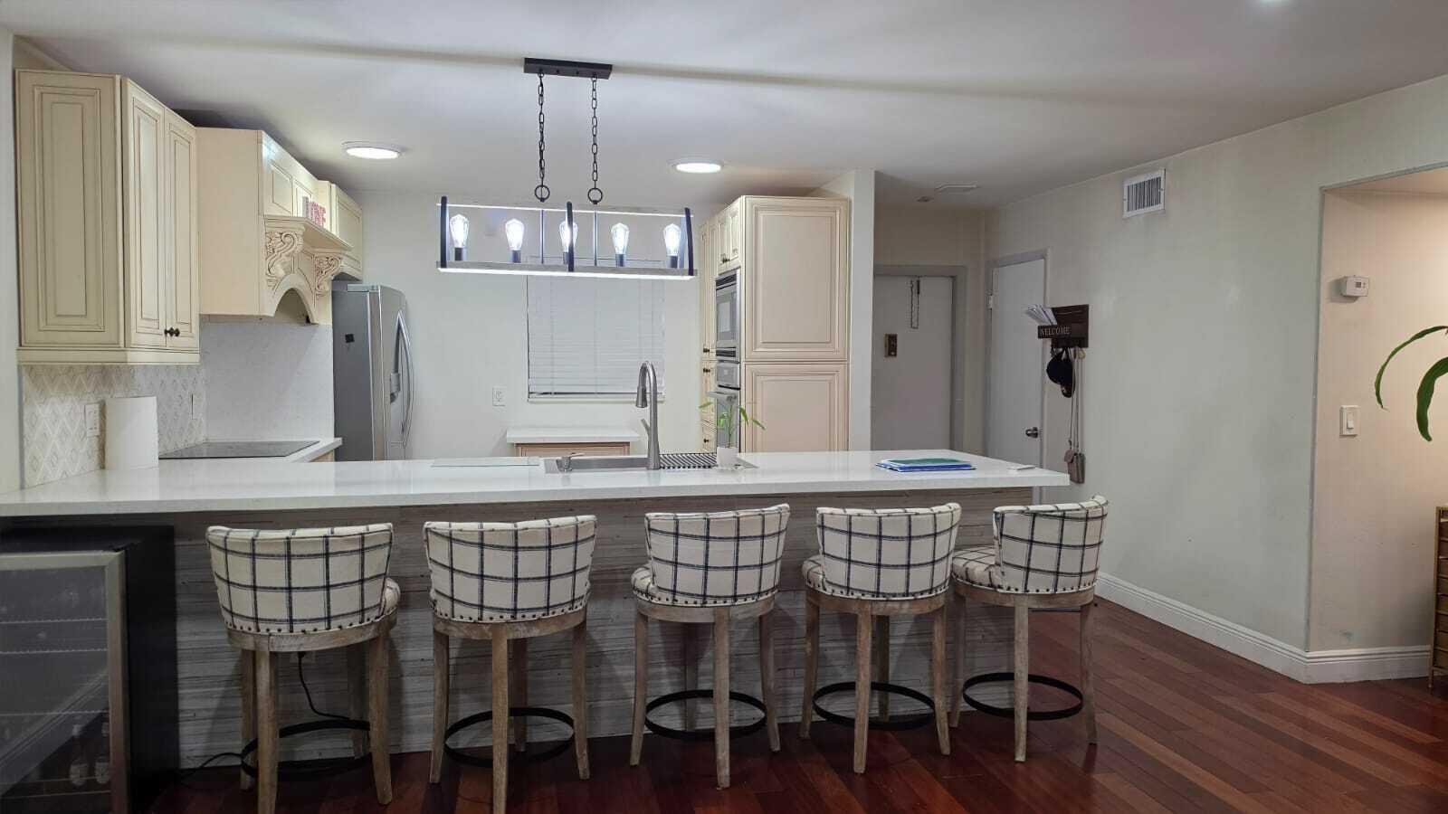100 Ashbury Road, Unit 206 Hollywood, FL 33024 - Photo 5 of 23 a kitchen with a table and chairs in it