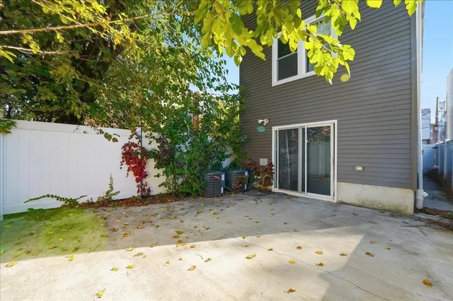a backyard of a house with table and chairs