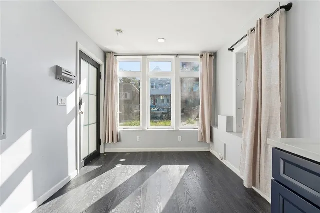 a view of hallway with windows and chandelier