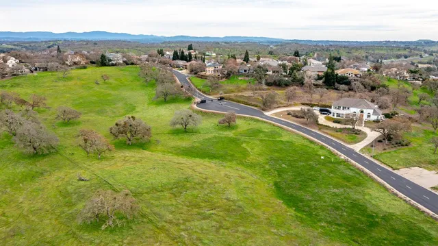 an aerial view of residential houses with outdoor space and river