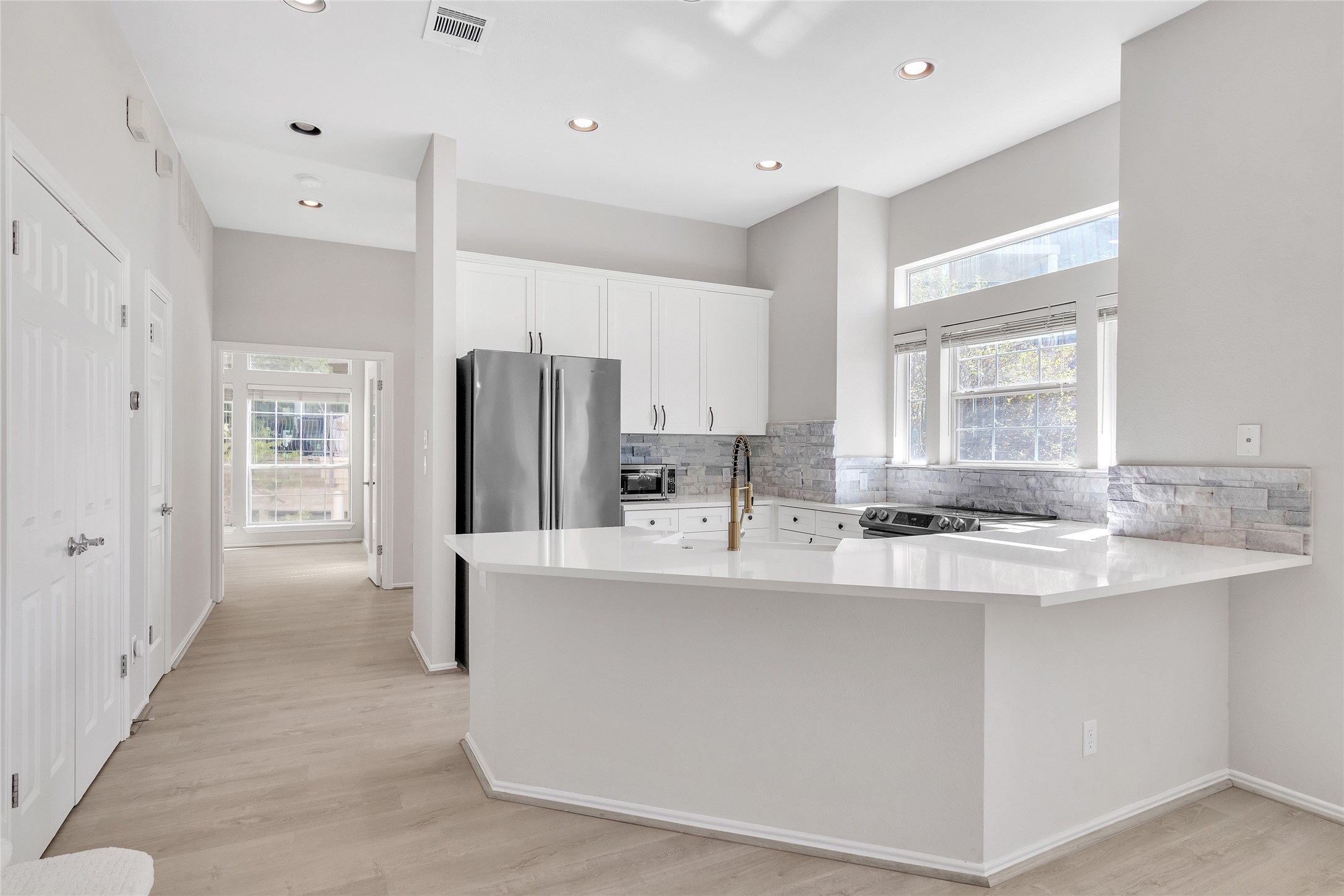 2918 Ranch Road 620 North, Unit 281 Austin, TX 78734 - Photo 4 of 32 a large kitchen with stainless steel appliances a sink window and refrigerator