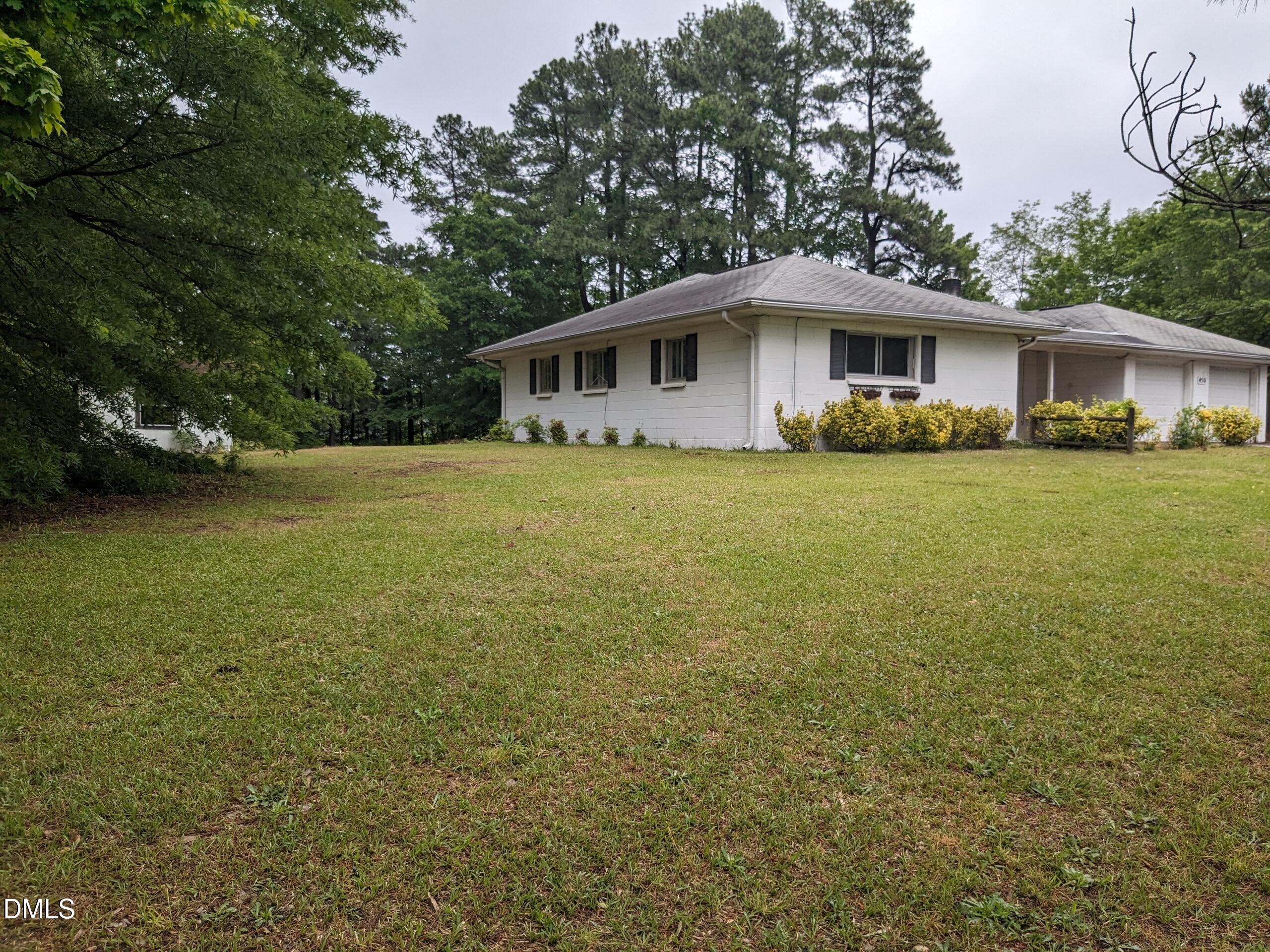 4511 Hopson Road Morrisville, NC 27560 - Photo 3 of 7 a front view of a house with a garden